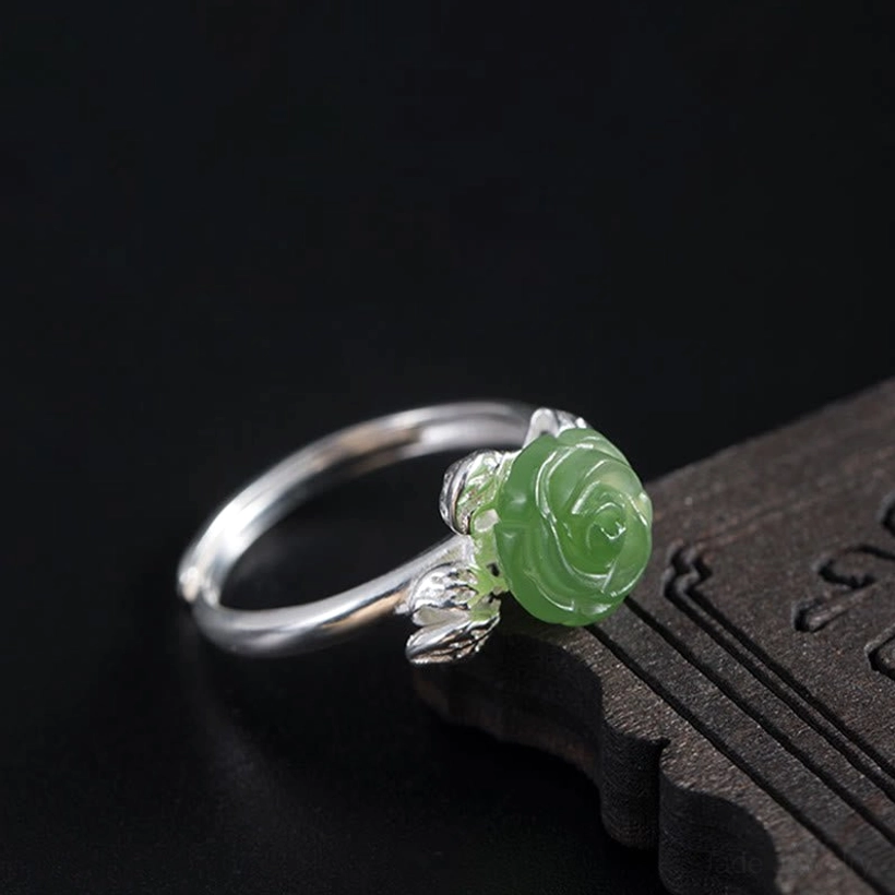 Hand-carved green jade rose ring showcasing natural stone variations and 925 sterling silver craftsmanship