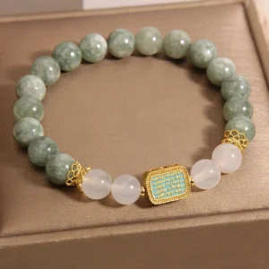 Green jade white agate Hah Taew five lines prosperity bracelet in gold gift box - top view flat lay