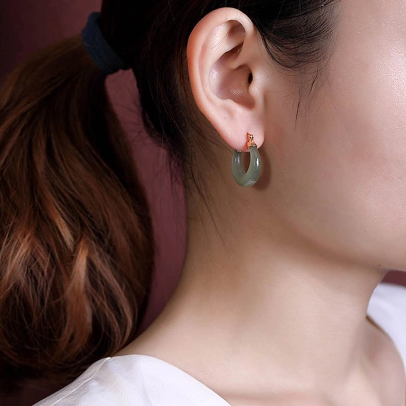 Handcrafted natural jade drop earrings detail shot revealing smooth polished stone texture and 925 sterling silver gold-plated hardware