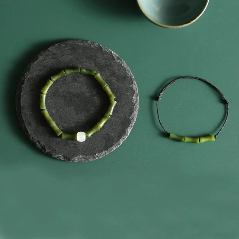 Handmade green bamboo jade bracelet with natural stone variations, close-up product shot