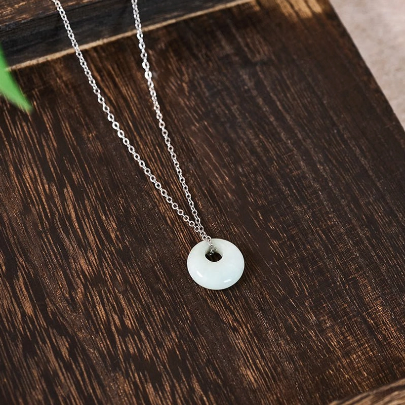 Handmade jade prosperity necklace pendant close-up showing craftsmanship and hollow design