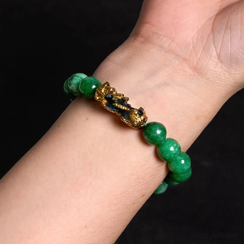 Feng shui Pi Xiu jade prosperity bracelet featuring handcrafted natural cyan jade beads with gold-plated wealth protection charm, artisan craftsmanship detail
