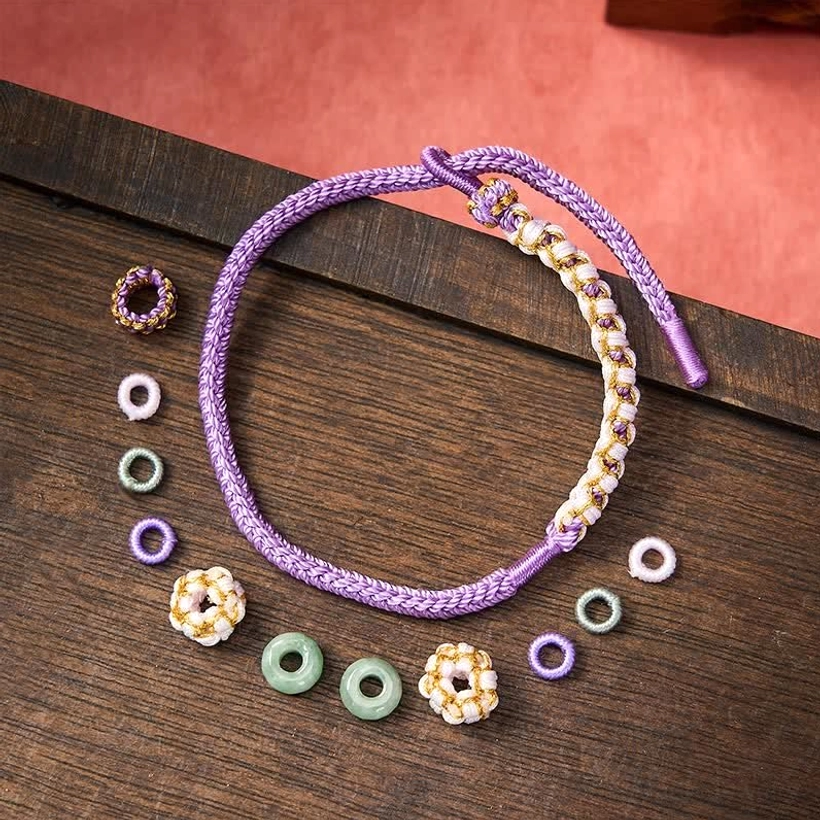 Handmade red string jade bracelet with protective knot design