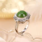 Hetian Cyan Jade Flower Ring in 925 Sterling Silver - 45-degree side view showcasing filigree silver setting and polished green jade stone