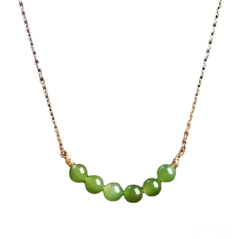 Top-down flat lay view of Hetian cyan jade beaded necklace with gold-toned chain showing seven jade beads in curved arrangement on wood grain surface - jade prosperity necklace overhead styling