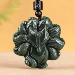 Hetian cyan jade nine-tailed fox pendant necklace front close-up with intricate carved details and cloud-patterned suspension cord