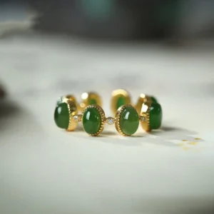 Hetian cyan jade adjustable ring with three oval green jade beads set in gold-toned sterling silver bezels, front view