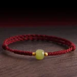 Hetian jade 999 gold beads red string protection bracelet overhead view