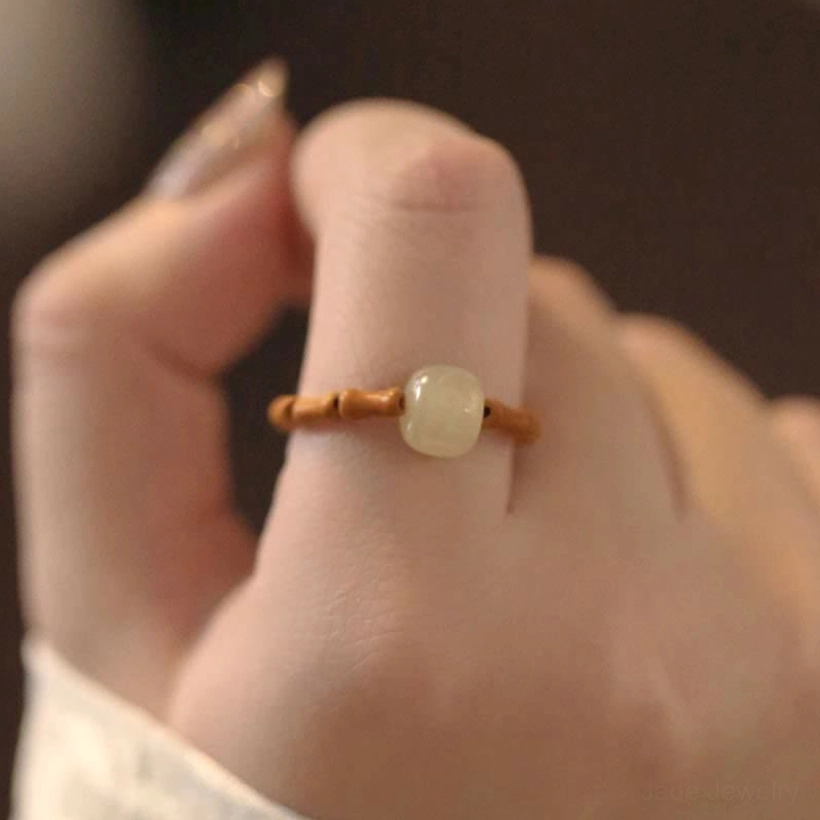 Close-up front view of bamboo-beaded hetian jade ring showing neatly arranged brown bamboo joint segments
