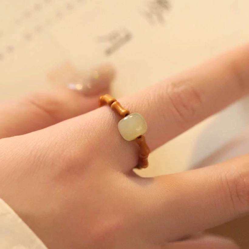 Close-up finger side view of adjustable hetian jade bamboo ring showing perfect fit and craftsmanship