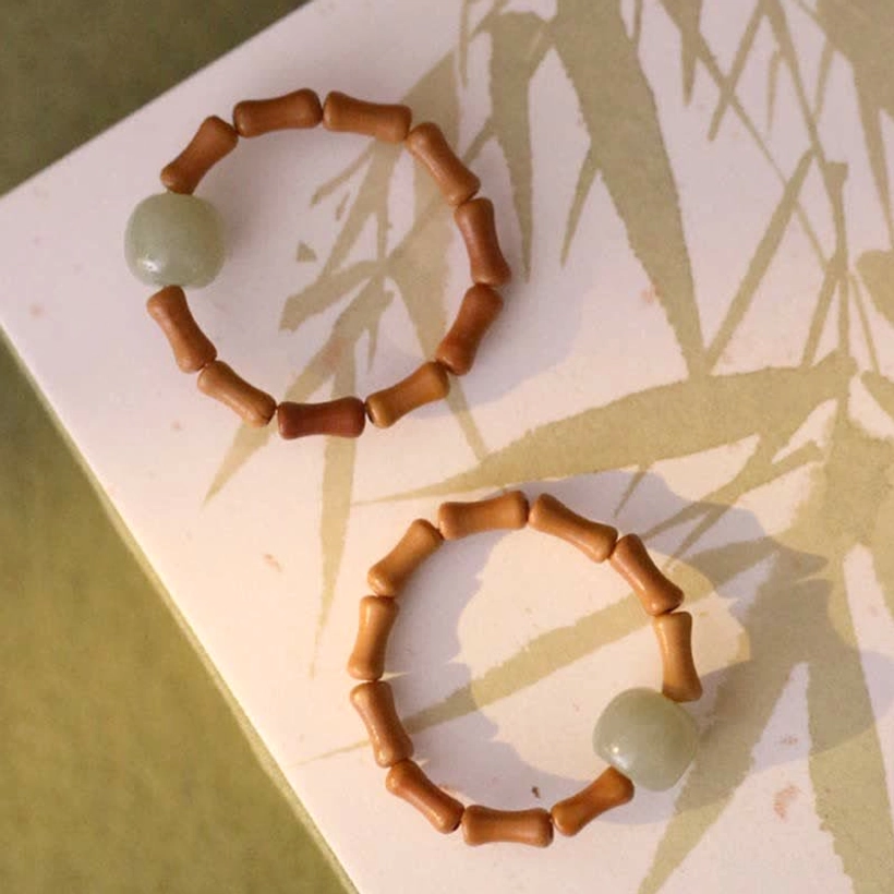 Hetian jade bamboo ring collection view showing natural variations and craftsmanship of handmade prosperity talisman