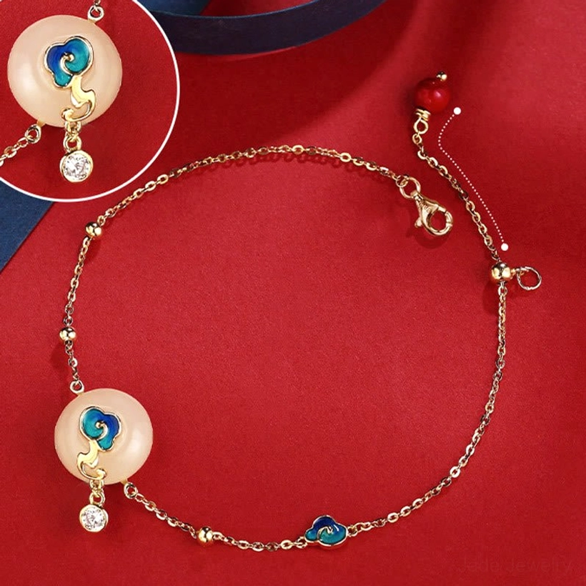 Hetian jade auspicious clouds bracelet close-up detail showing gold chain, jade peace buckle, and red bead adjuster
