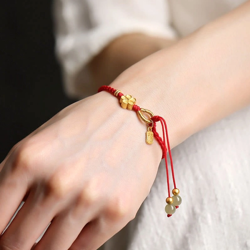Hetian jade bracelet worn on wrist showing real-world fit and comfort of red string with jade charms