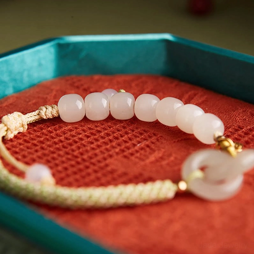 Hetian jade braided bracelet side wrist close-up showing gold charm and interlocking buckles