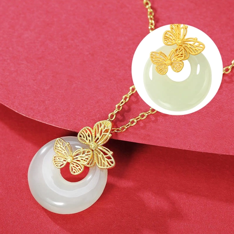 Sterling silver butterfly jade necklace pendant with circular magnified close-up highlighting the polished light green jade and intricate butterfly craftsmanship