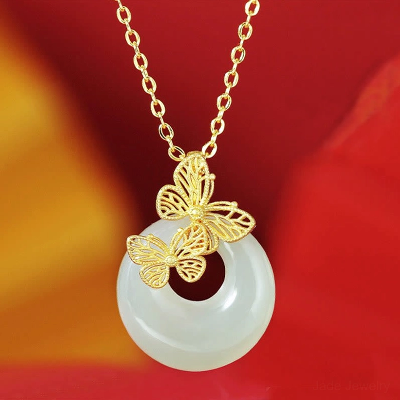 Hetian jade butterfly pendant necklace with two gold filigree butterflies on light green jade donut, paired with elegant gold-toned sterling silver chain - overhead front view