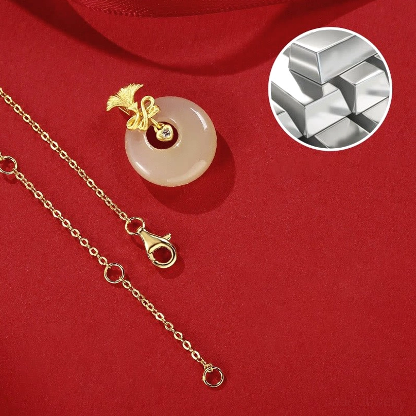 Loose hetian jade pendant separated from 18k gold-plated necklace chain showing pale jade color