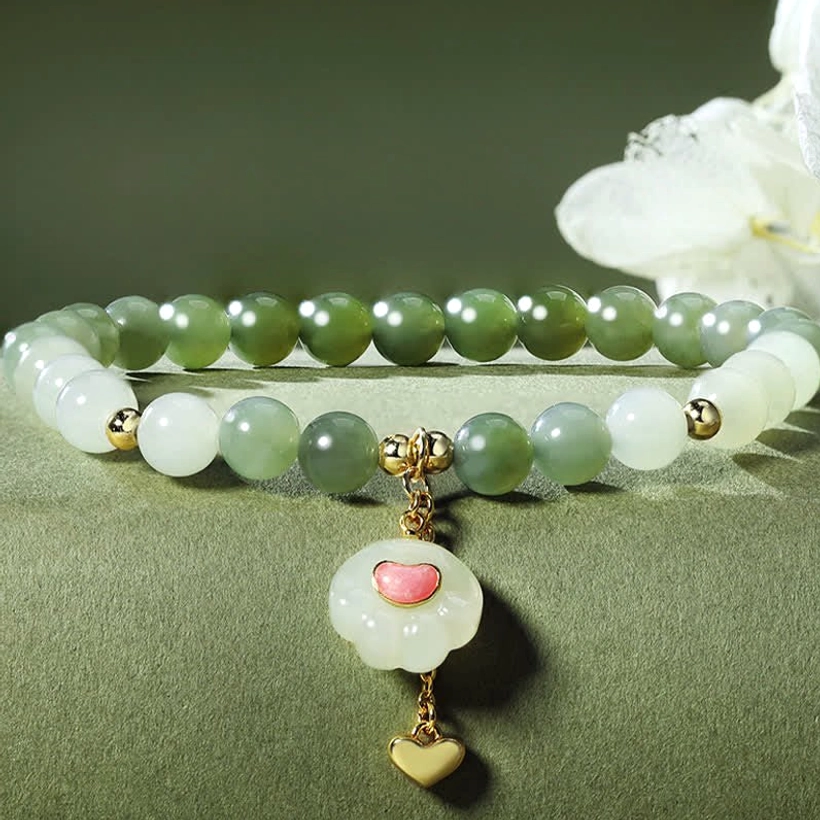 Double strand Hetian jade cat paw charm bracelet close-up detail with matching heart pendant and gold accents