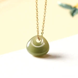Hetian jade child lock pendant necklace with gold chain - natural olive-green donut jade charm overhead front view
