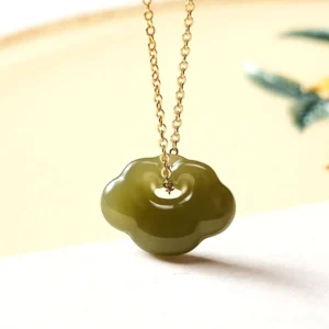 Hetian jade cloud lock pendant necklace with light celadon green jade and sterling silver or copper chain in flat lay on natural background