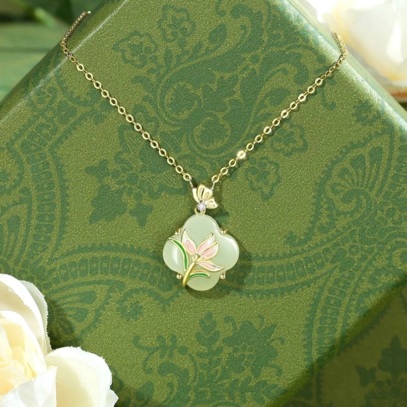Four leaf clover Hetian jade pendant necklace with magnolia butterfly design in 925 sterling silver with 14k gold plating on gift box background