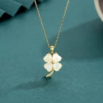 Hetian jade four leaf clover pendant necklace with gold-tone 925 sterling silver chain - overhead front view