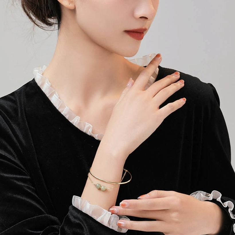 Hetian jade double layer bangle bracelet lifestyle wear showing elegant jade beads with warm gold plated finish