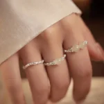 Hand wearing stackable Hetian jade elastic rings with 925 sterling silver beads - daily wear jewelry display