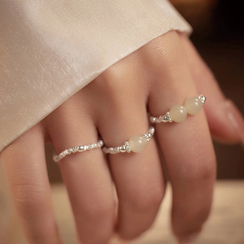 Hand wearing stackable Hetian jade elastic rings with 925 sterling silver beads - daily wear jewelry display