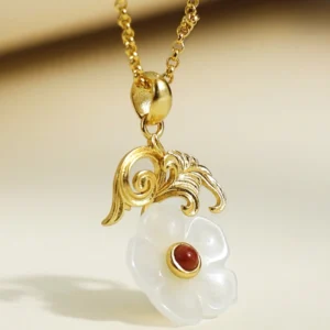 Gold scrollwork detail on Hetian jade flower necklace, ornate sterling silver bail with handcrafted flourishes