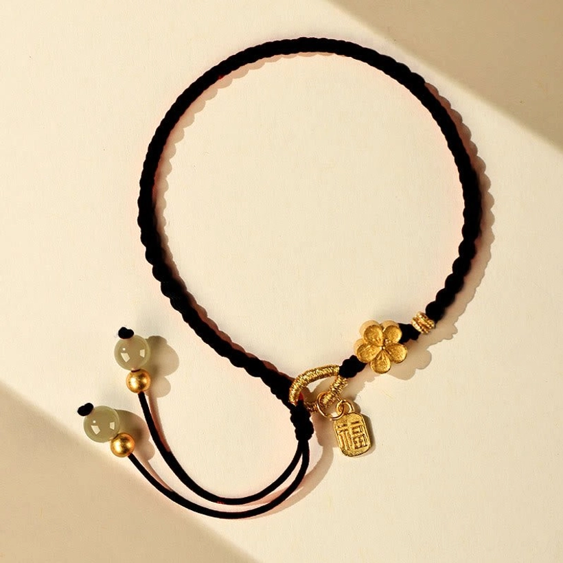 Red rope hetian jade fu peach blossom bracelet featuring traditional fu character charm and jade beads
