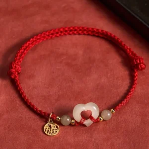 Hetian jade heart fu character red string blessing bracelet flat lay top view