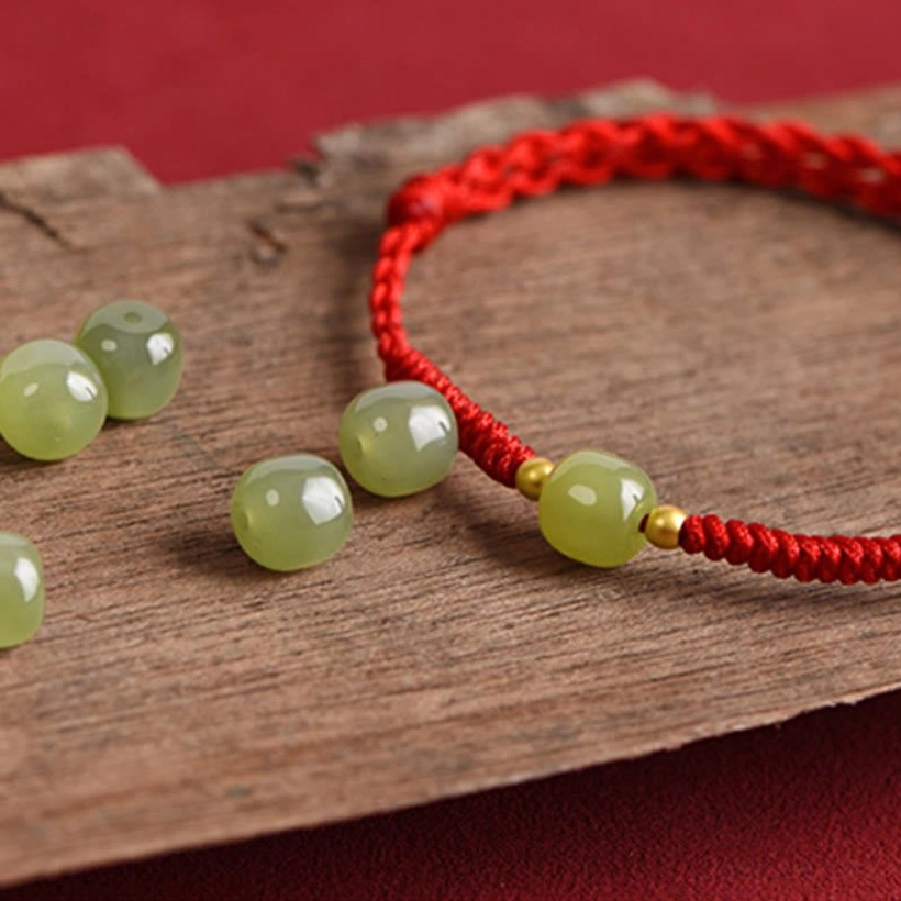 Hetian jade protection bracelet with gold accents ancient symbol