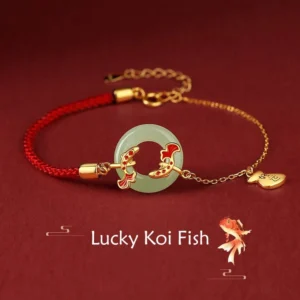 Hetian jade koi fish peace buckle bracelet with sterling silver charm on red studio background, overhead view