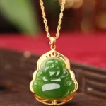 Hetian jade laughing Buddha pendant necklace with 925 sterling silver and 18K gold frame, overhead view on red velvet