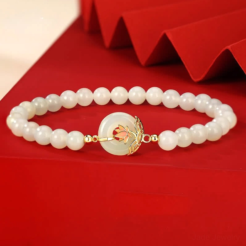 Hetian white jade lotus peace buckle bracelet with 925 sterling silver charm, top-down view showing uniform round jade beads and ornate lotus peace buckle