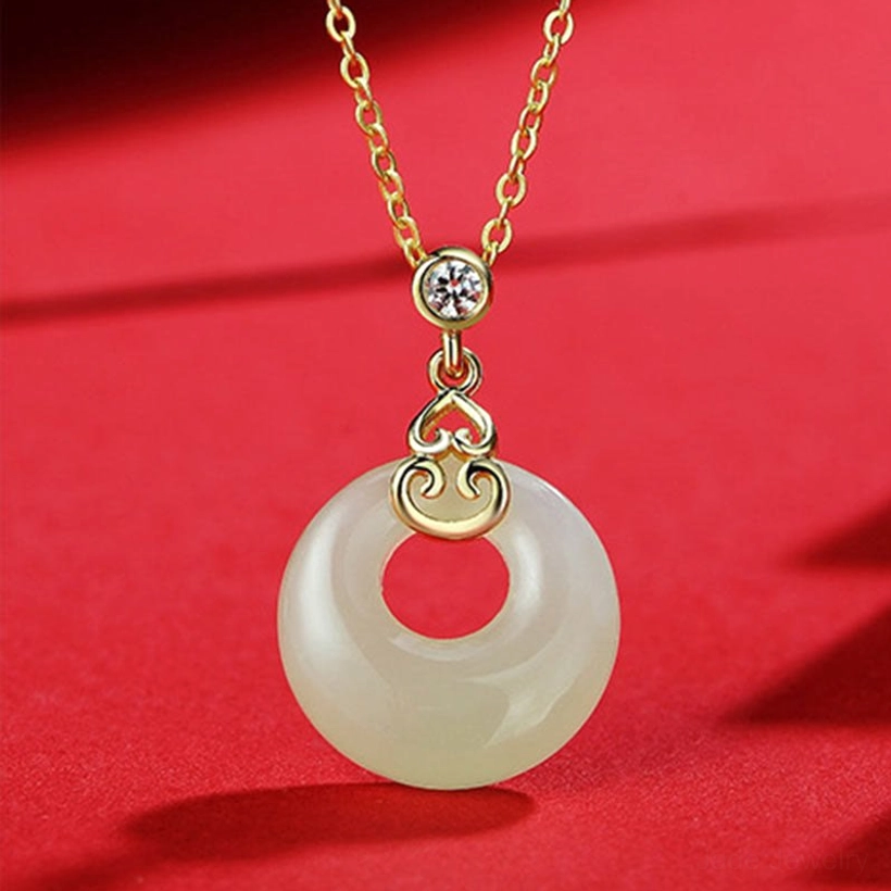 Hetian jade gourd peace buckle necklace flat lay showing pendant detail, sterling silver chain, and red cord