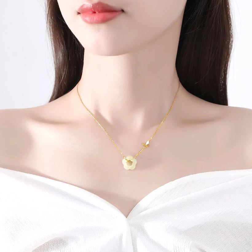 Woman wearing delicate Hetian jade butterfly flower necklace on collarbone, worn jewelry styling
