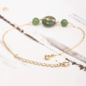 Close-up detail of adjustable gold chain with secure lobster clasp on Hetian jade peace buckle bracelet with jade beads