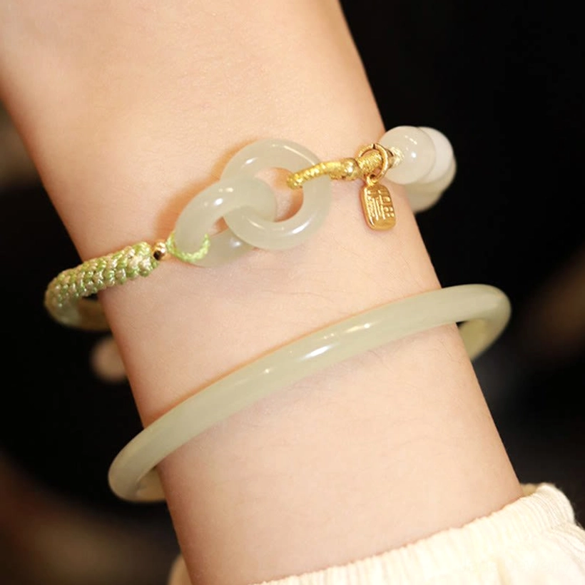 Hetian jade peace buckle bracelet and bangle set worn on wrist with green jade accent