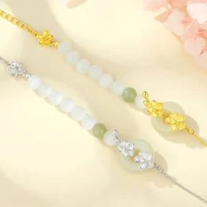 Two variations of Hetian jade peace buckle bracelets in sterling silver and gold-plated finishes with jade beads and flower charms