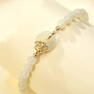 Side close-up view of Hetian jade peace buckle bracelet highlighting the gold sterling silver clasp and beaded strand detail