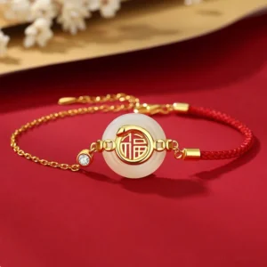 925 sterling silver Hetian jade Fu peace buckle bracelet with red braided cord and gold accents on decorative background