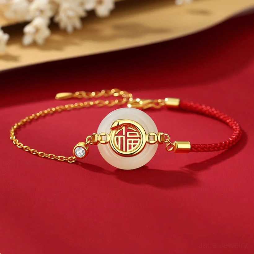 925 sterling silver Hetian jade Fu peace buckle bracelet with red braided cord and gold accents on decorative background