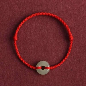 Bright red woven Hetian jade peace buckle bracelet close-up detail view