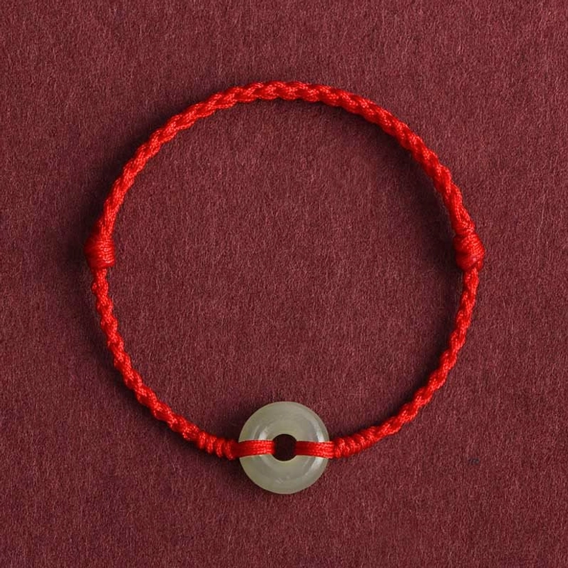 Bright red woven Hetian jade peace buckle bracelet close-up detail view