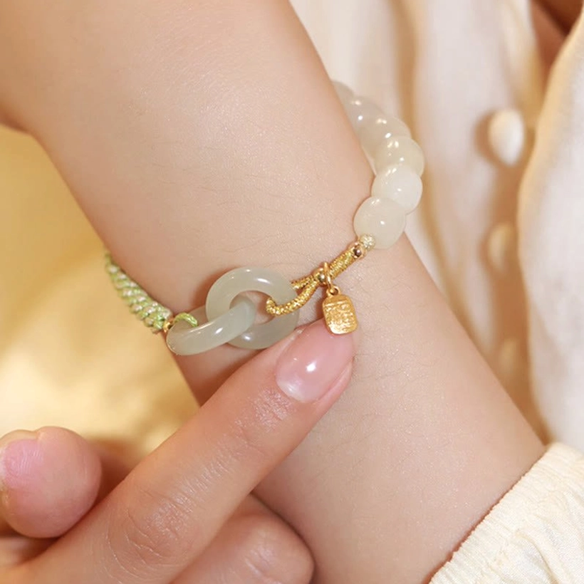 Hetian jade peace buckle bracelet front wrist view with gold charm and green woven band