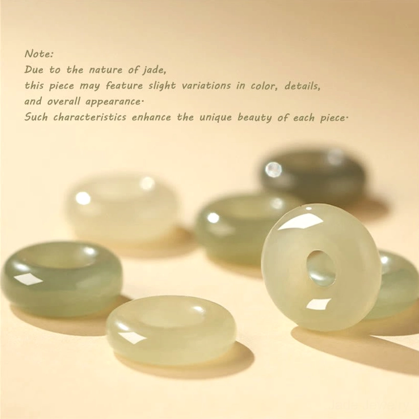 Multiple natural Hetian jade peace buckles showing varied color tones from light to dark nephrite