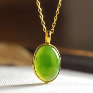 Close-up front view of authentic Hetian jade pendant necklace featuring rich green natural jade stone with polished silver bezel, highlighting jade quality and artisan craftsmanship detail