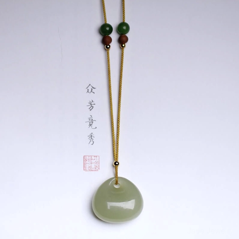 Hetian jade prosperity necklace close-up, polished light green jade stone small bag charm design detail shot